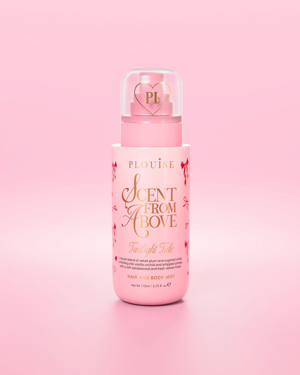Pink bottle of Scent From Above hair and body mist with red bow designs against a pink background