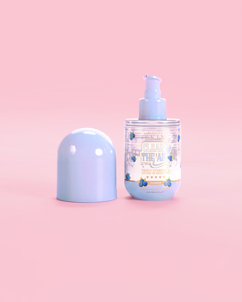 Bottle of P. Louise Clear The Air Blueberry Gel Cleanser with the cap off on a pink background
