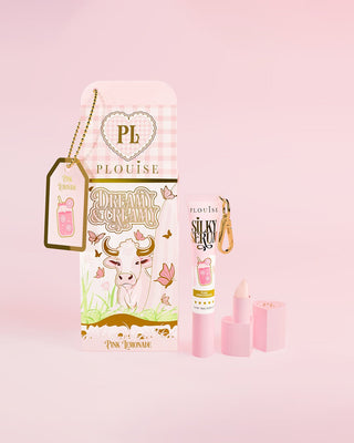 Pink Dreamy & Creamy milk carton with cows on next to a pink lemonade lip serum and lipstick shaped lip balm