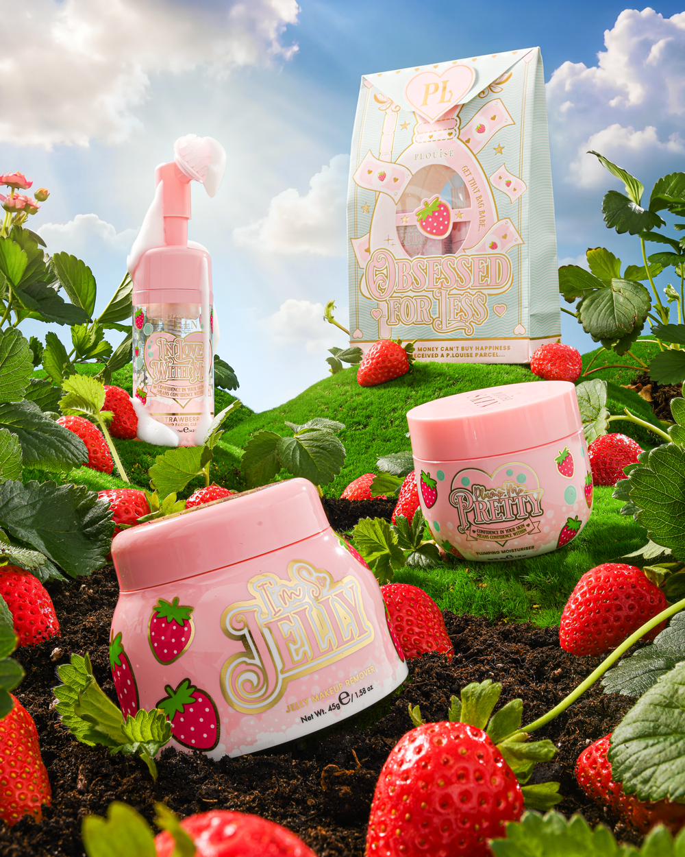 P.Louise Strawberry Obsessed For Less Double Cleanse & Moisturise Skincare Set on a grassy hill surrounded by strawberries