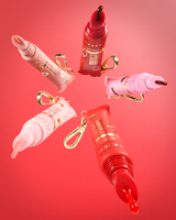 Red and pink cherry-scented tinted protect your pout lip conditioner tubes on a red background