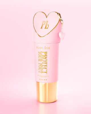 Giant pink and gold Protect Your Pout bottle with heart-shaped cap on a light pink background